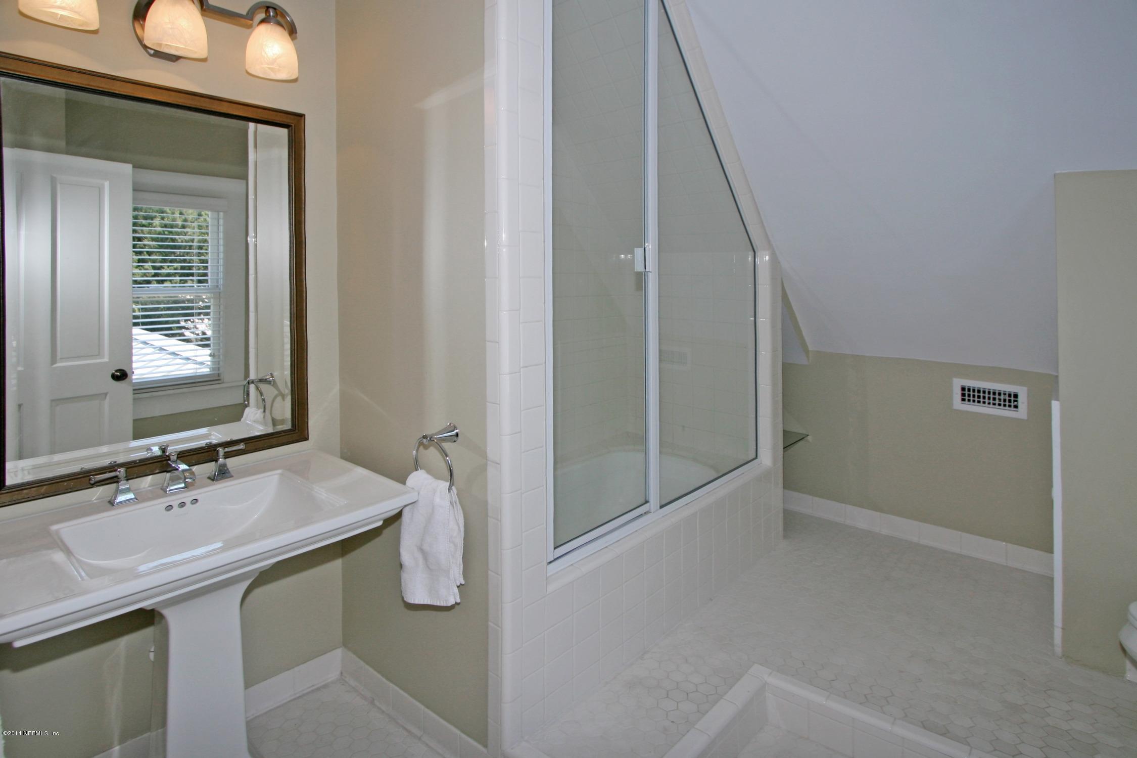 48 Water Street St. Augustine, FL 32084 - Photo 39 of 52 a bathroom with a granite countertop sink a toilet and shower