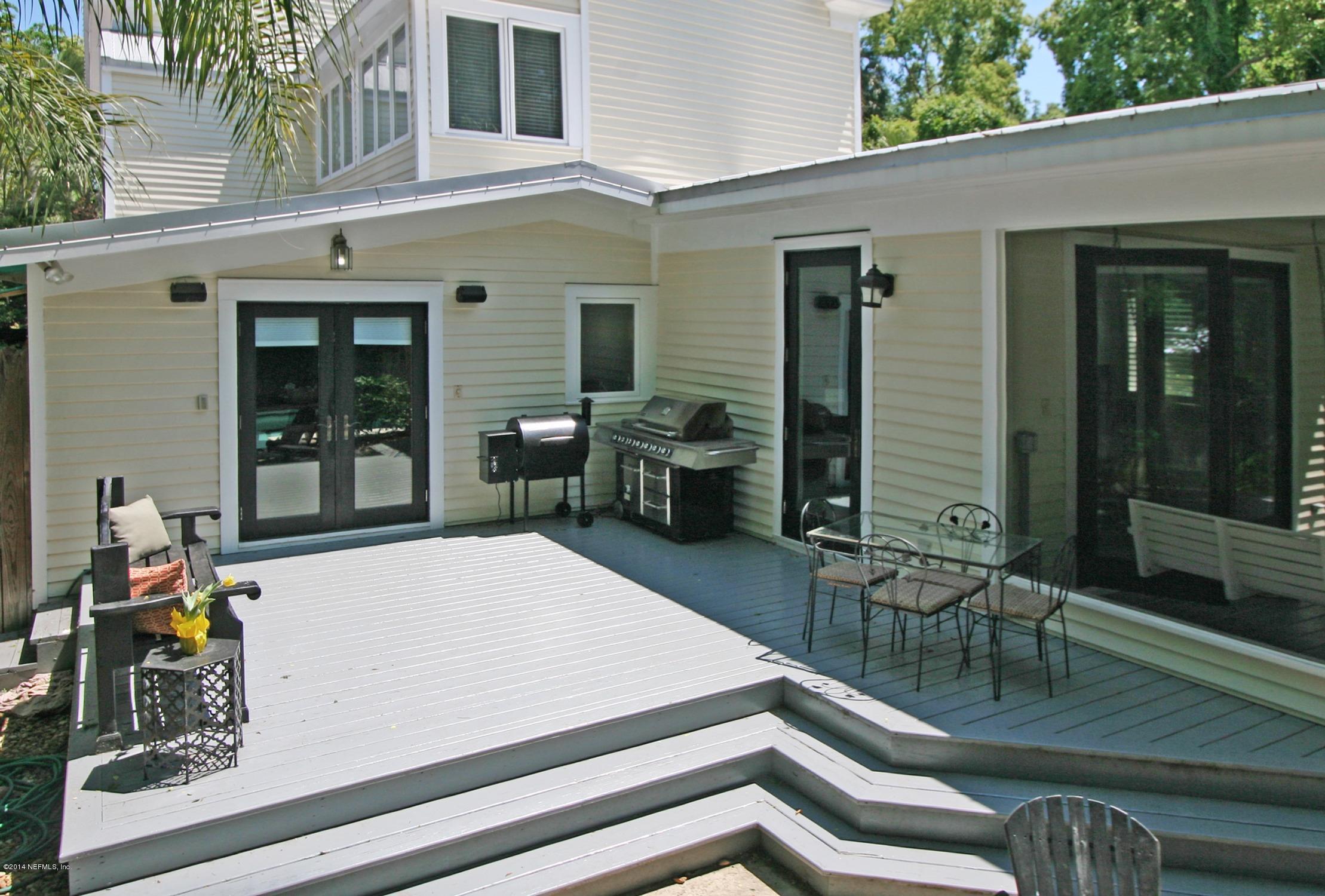 48 Water Street St. Augustine, FL 32084 - Photo 43 of 52 a view of a patio with table and chairs with wooden floor and fence