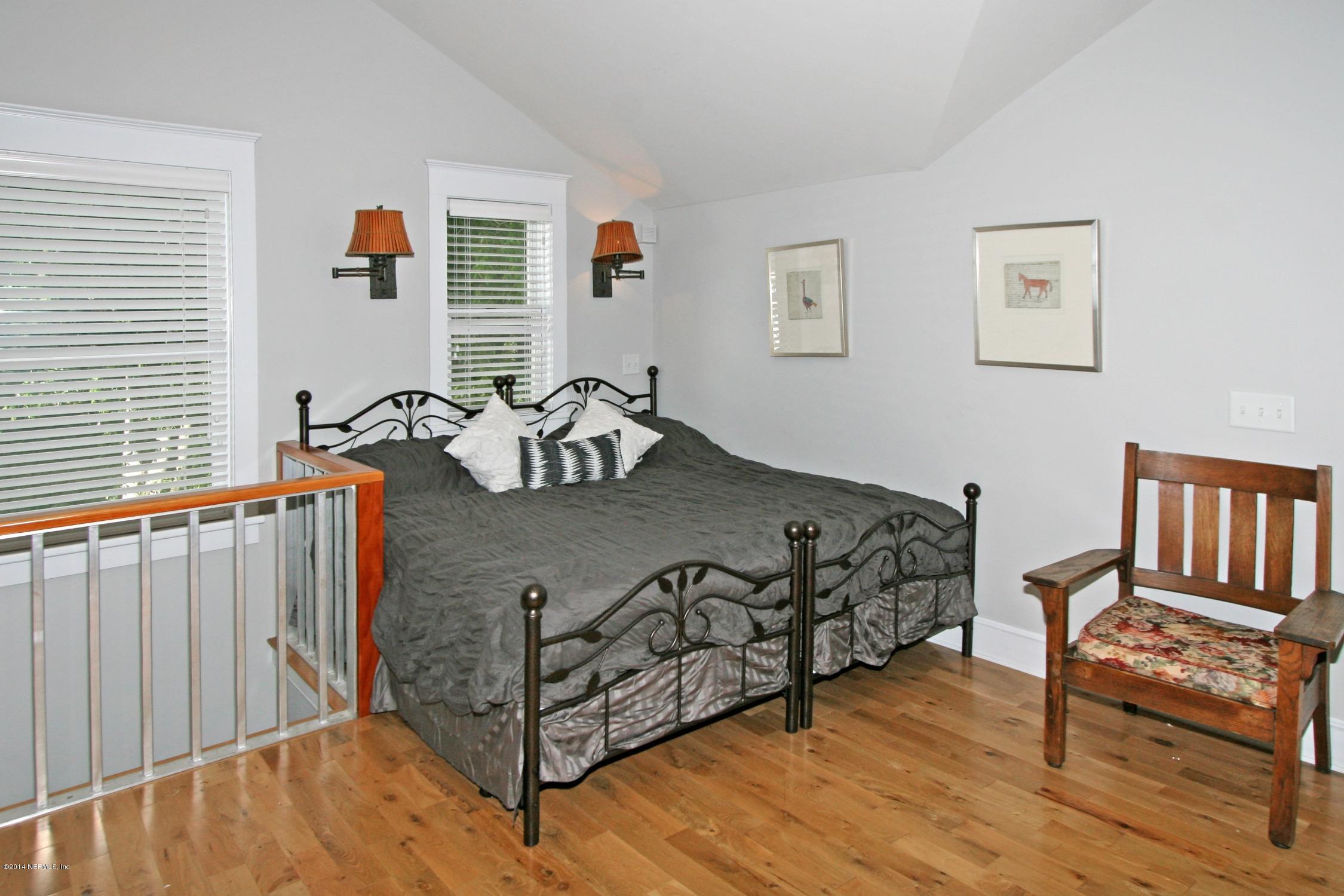 48 Water Street St. Augustine, FL 32084 - Photo 48 of 52 a bedroom with a bed and wooden floor