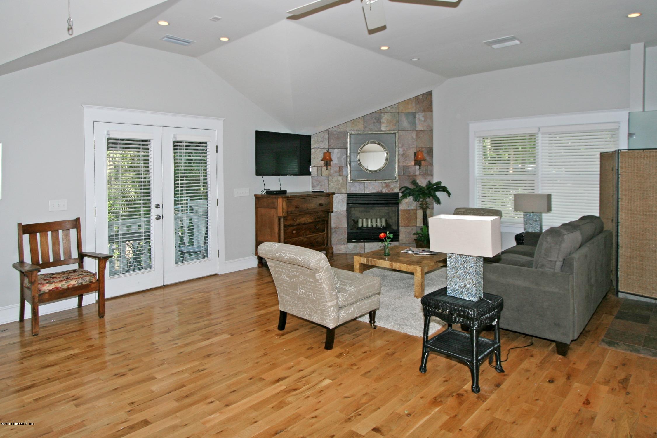 48 Water Street St. Augustine, FL 32084 - Photo 49 of 52 a living room with furniture a fireplace and a flat screen tv