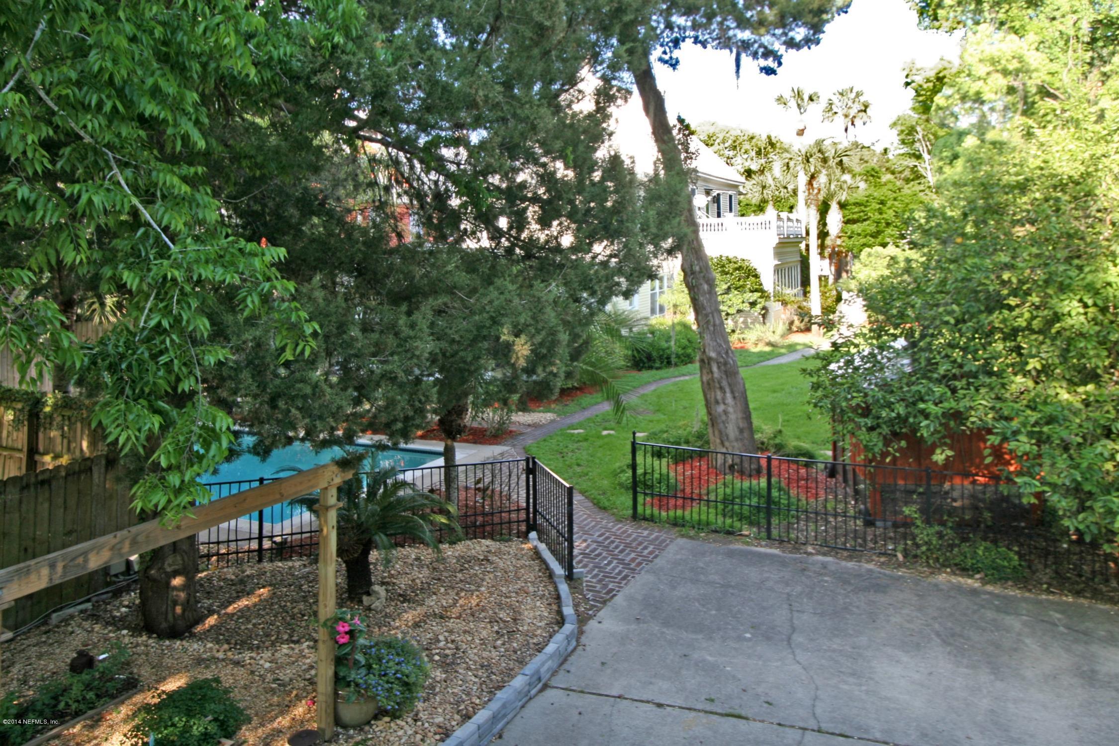 48 Water Street St. Augustine, FL 32084 - Photo 51 of 52 a green field with lots of trees in the background