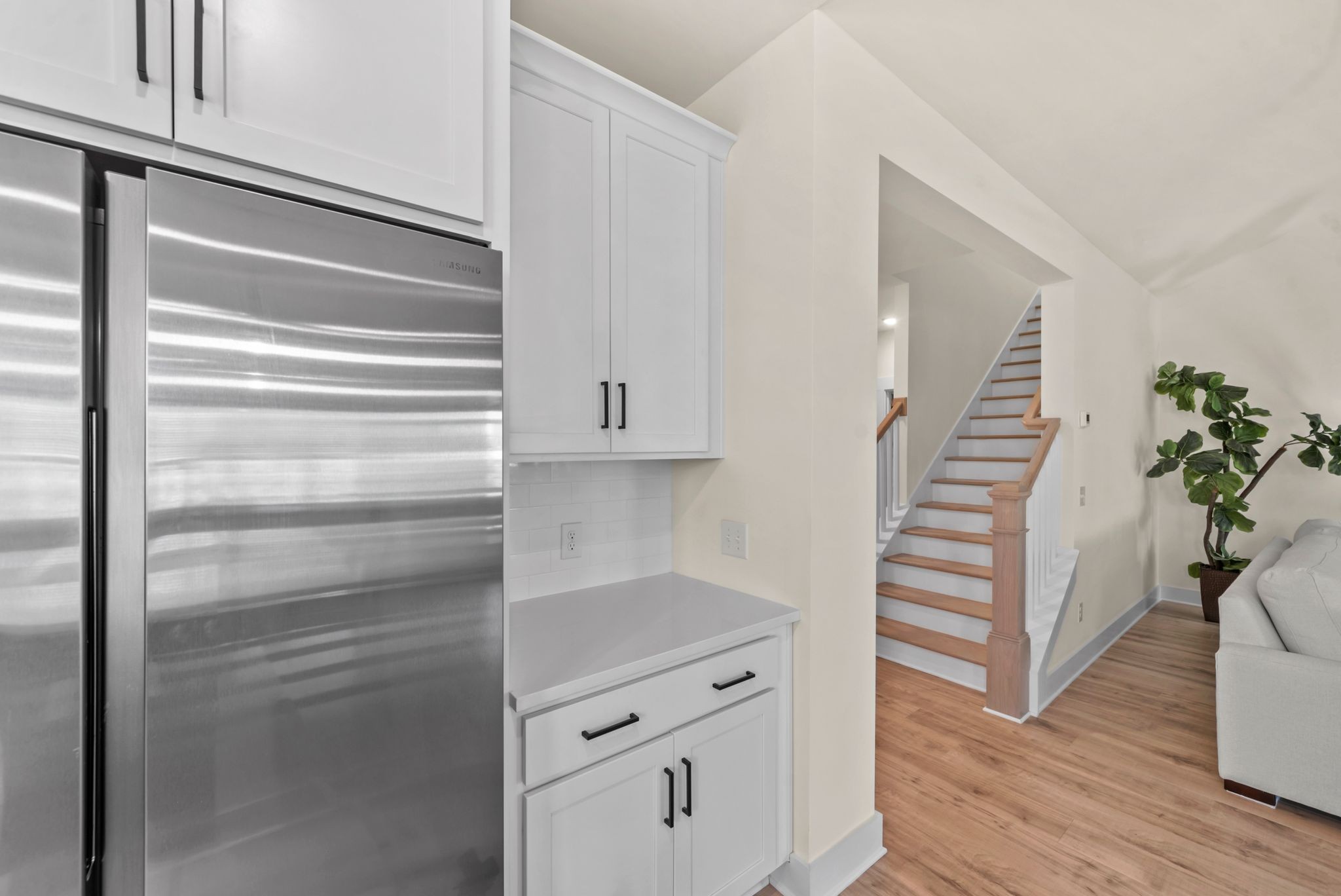 4043 John Marsh Road Spring Hill, TN 37174 - Photo 29 of 56 a kitchen with white cabinets and wooden floor