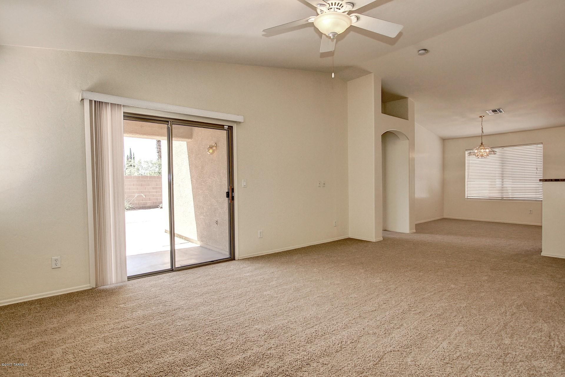 8350 East Bowline Road Tucson, AZ 85710 - Photo 10 of 26 an empty room with fan and windows