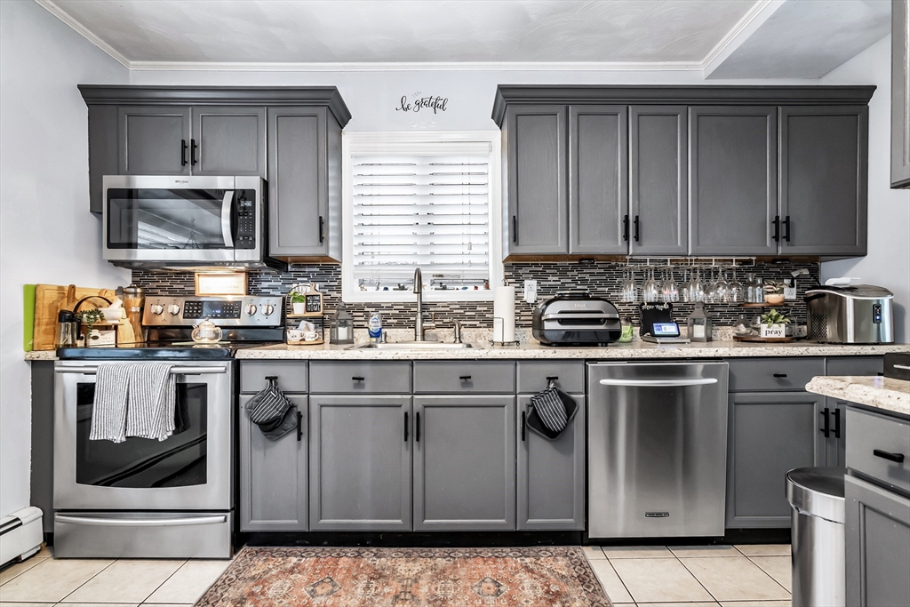 2 Maurice Avenue Lawrence, MA 01841 - Photo 13 of 36 a kitchen with granite countertop a sink stove and microwave