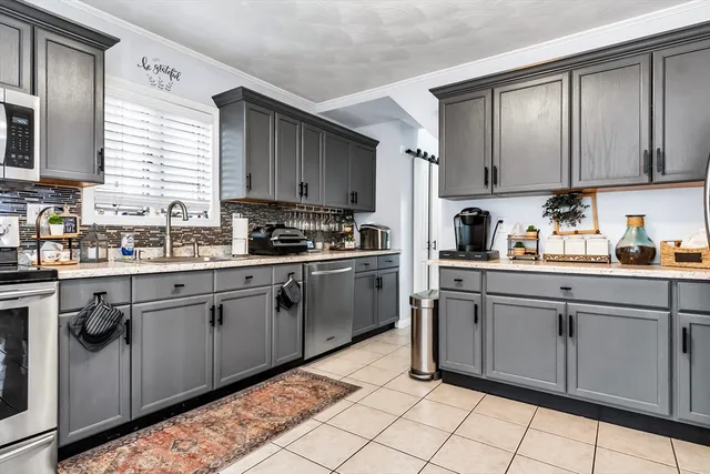 a kitchen with cabinets a sink and appliances