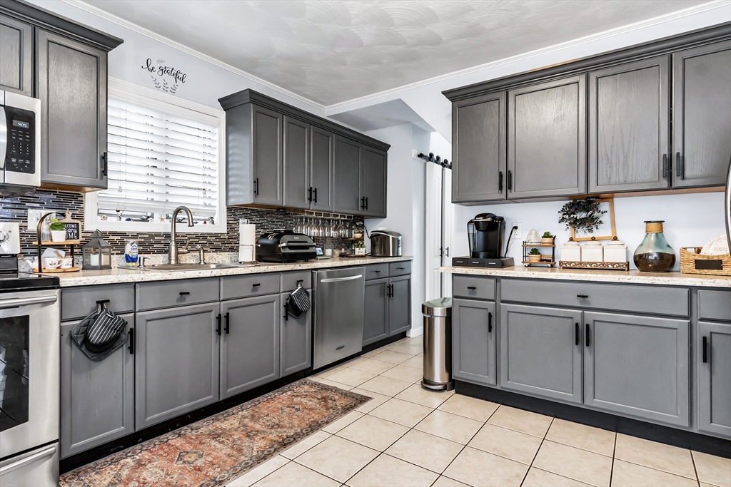 2 Maurice Avenue Lawrence, MA 01841 - Photo 14 of 36 a kitchen with cabinets a sink and appliances