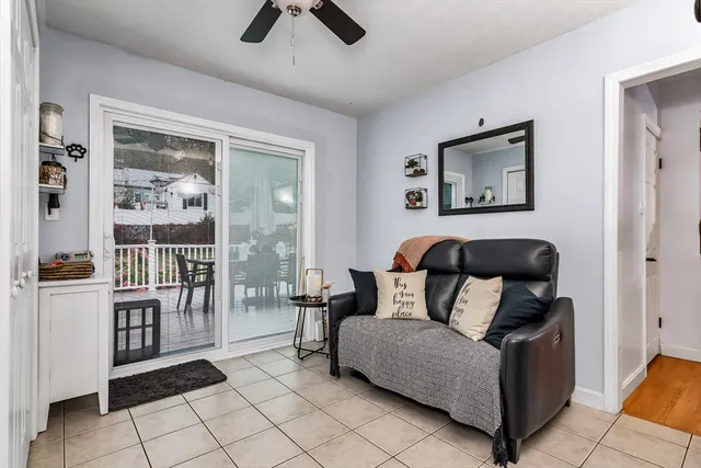 a living room with furniture a rug and white walls
