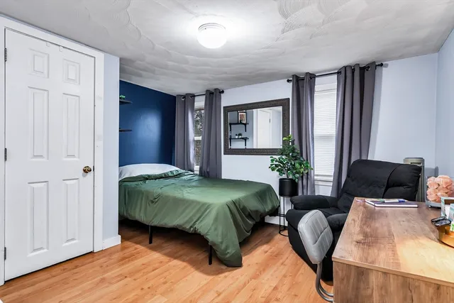 a spacious bedroom with a bed and window