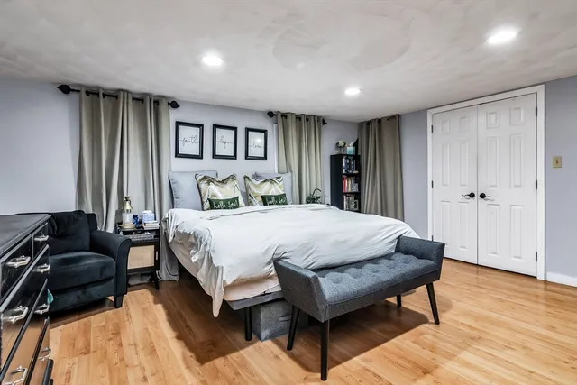 a spacious bedroom with a bed and a couch