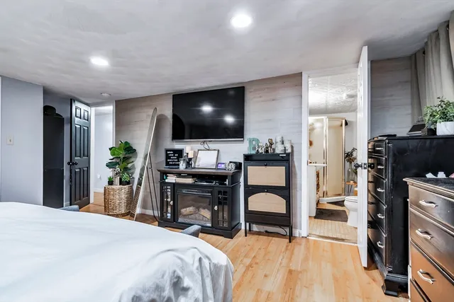 a bedroom with a bed and a television