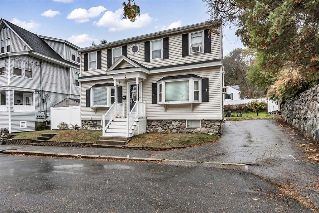 2 Maurice Avenue Lawrence, MA 01841 - Photo 3 of 36 a front view of a house with a garden