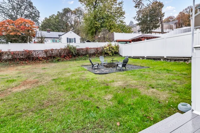a view of a house with a yard and sitting area