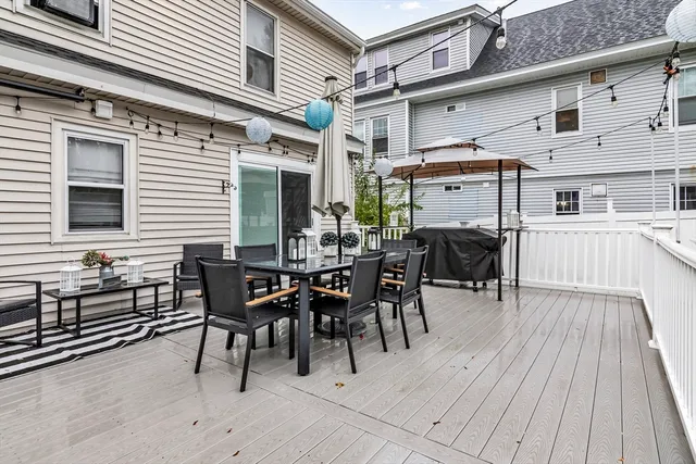 a view of a patio with table and chairs and wooden floor