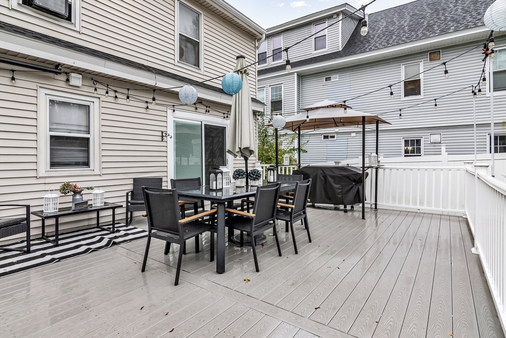 2 Maurice Avenue Lawrence, MA 01841 - Photo 33 of 36 a view of a patio with table and chairs and wooden floor