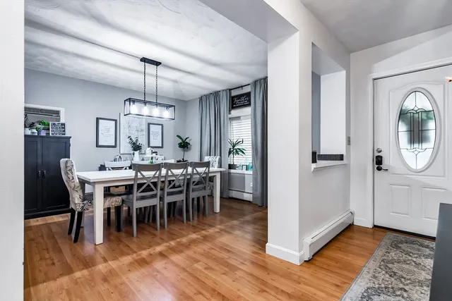 a view of a dining room with furniture window and wooden floor