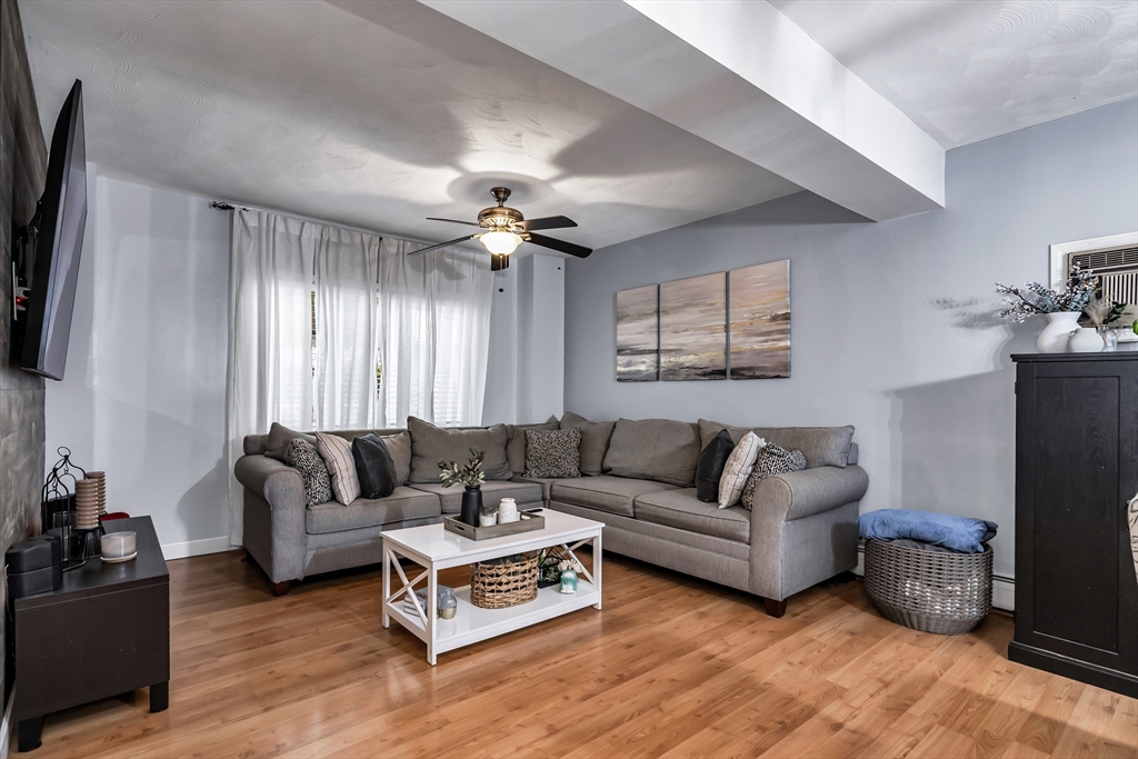2 Maurice Avenue Lawrence, MA 01841 - Photo 8 of 36 a living room with furniture a ceiling fan a lamp and a window
