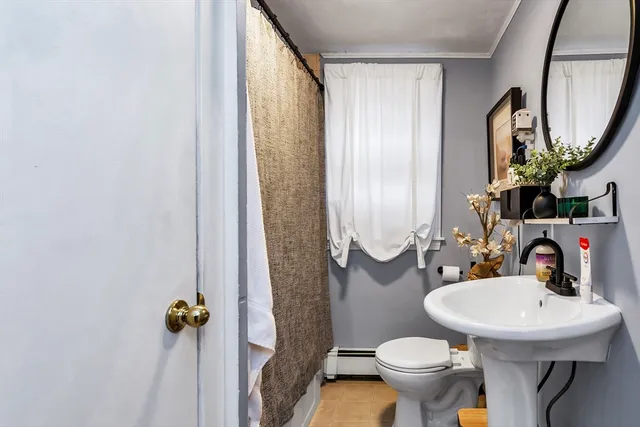 a bathroom with a sink toilet and mirror