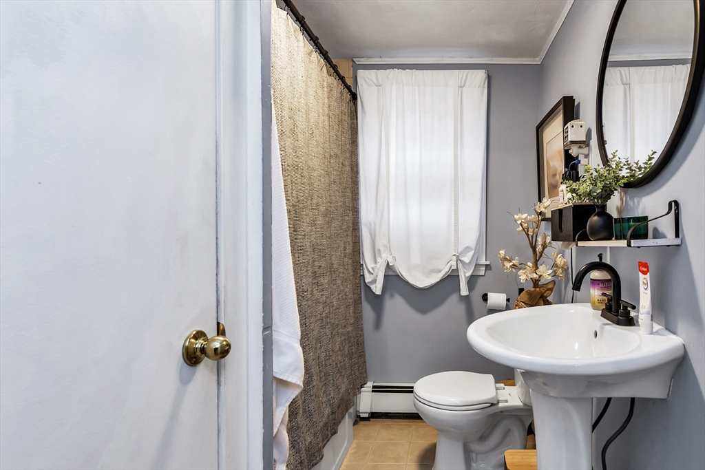 2 Maurice Avenue Lawrence, MA 01841 - Photo 10 of 36 a bathroom with a sink toilet and mirror