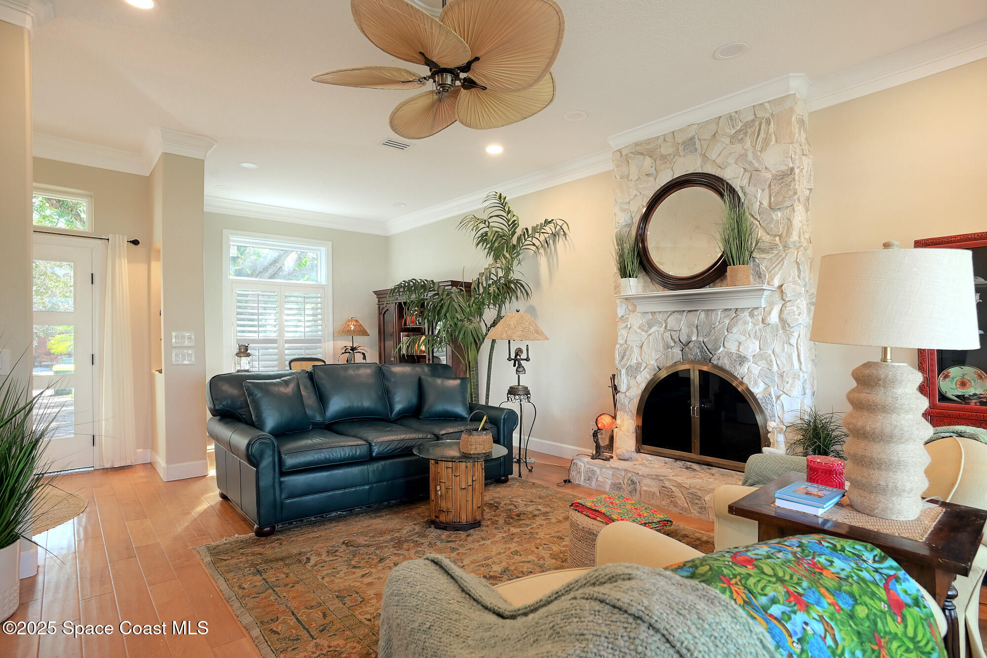 5930 Riverside Drive Melbourne Beach, FL 32951 - Photo 17 of 46 a living room with furniture a fireplace and potted plants