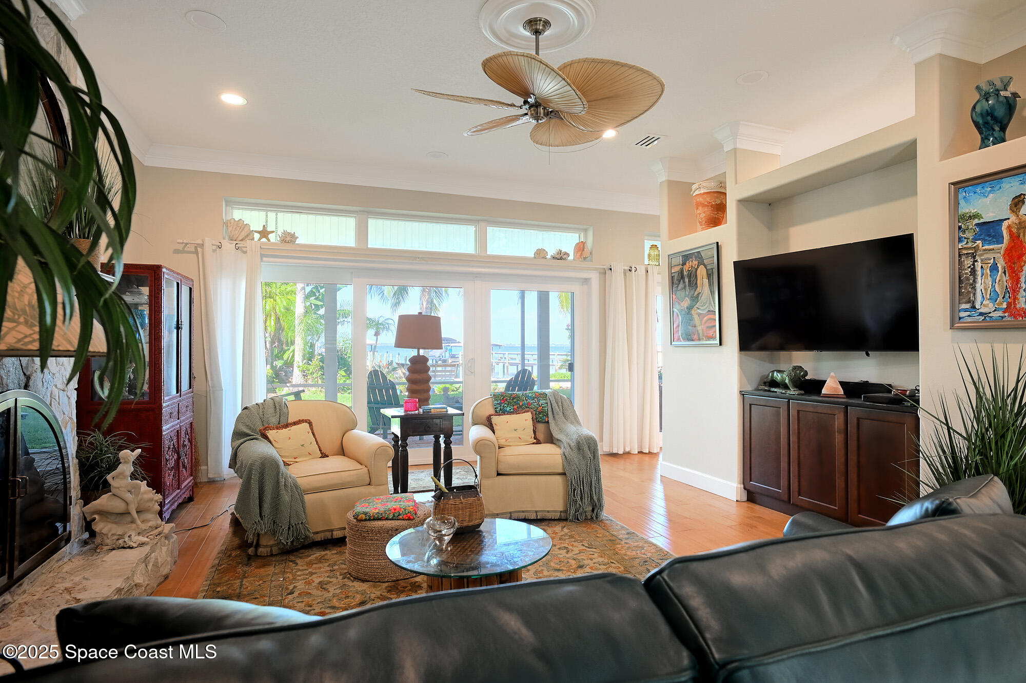 5930 Riverside Drive Melbourne Beach, FL 32951 - Photo 18 of 46 a living room with furniture and a flat screen tv