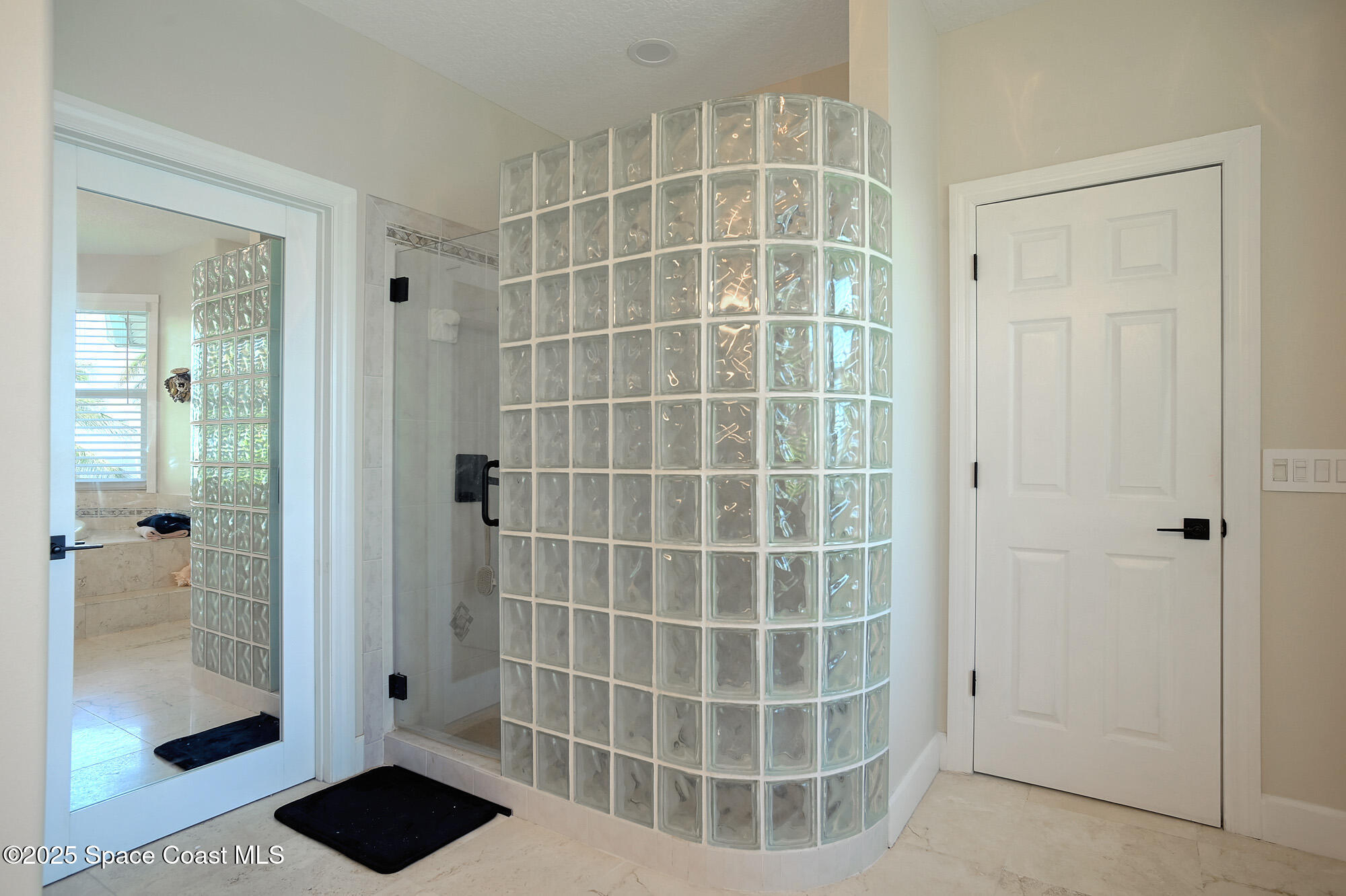 5930 Riverside Drive Melbourne Beach, FL 32951 - Photo 23 of 46 a bathroom with a glass door shower