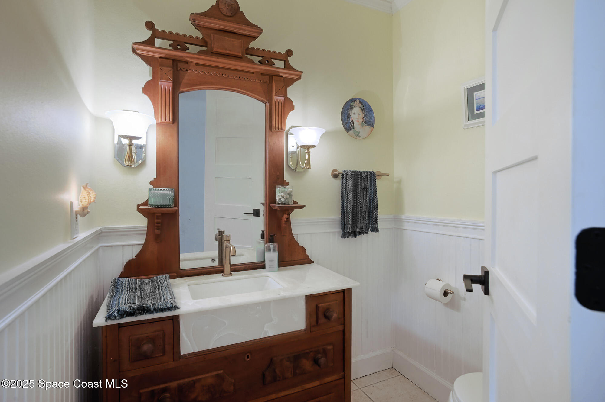 5930 Riverside Drive Melbourne Beach, FL 32951 - Photo 24 of 46 a bathroom with a sink and a mirror