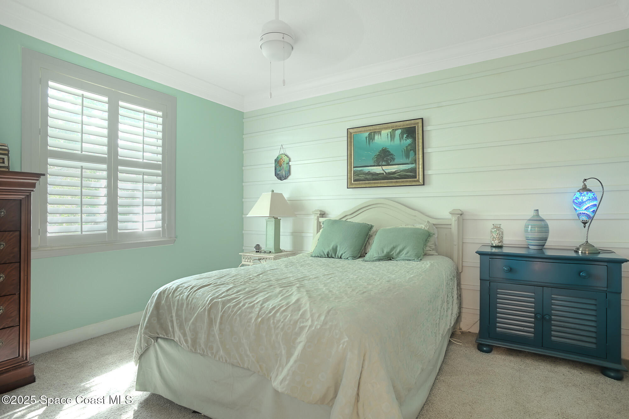 5930 Riverside Drive Melbourne Beach, FL 32951 - Photo 26 of 46 a bedroom with a bed and a window