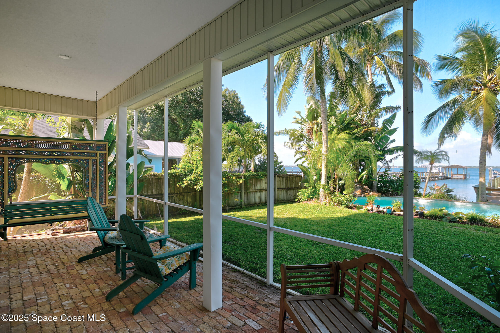 5930 Riverside Drive Melbourne Beach, FL 32951 - Photo 28 of 46 a view of a porch with chairs and backyard