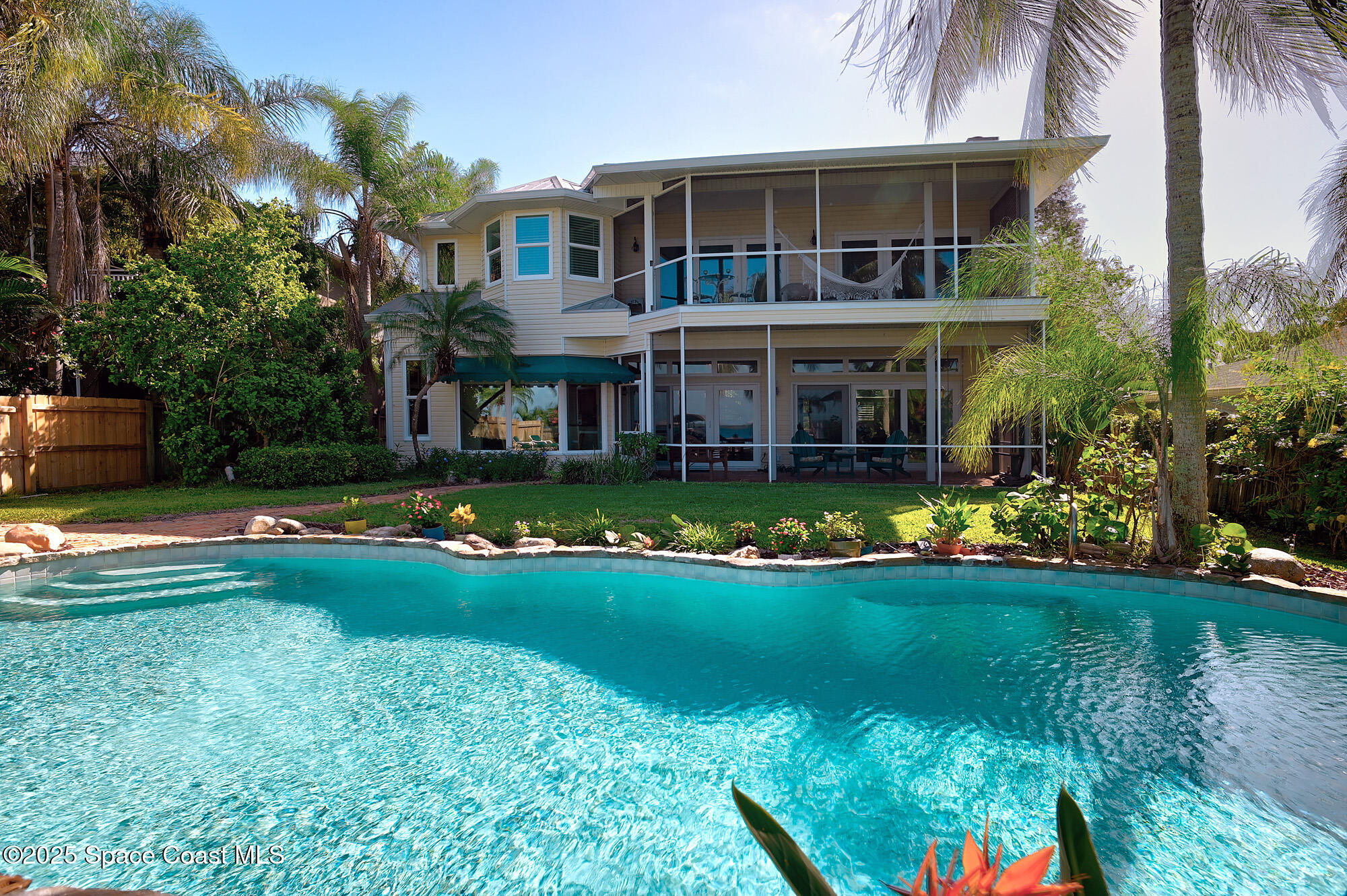 5930 Riverside Drive Melbourne Beach, FL 32951 - Photo 29 of 46 a front view of a house with swimming pool having outdoor seating