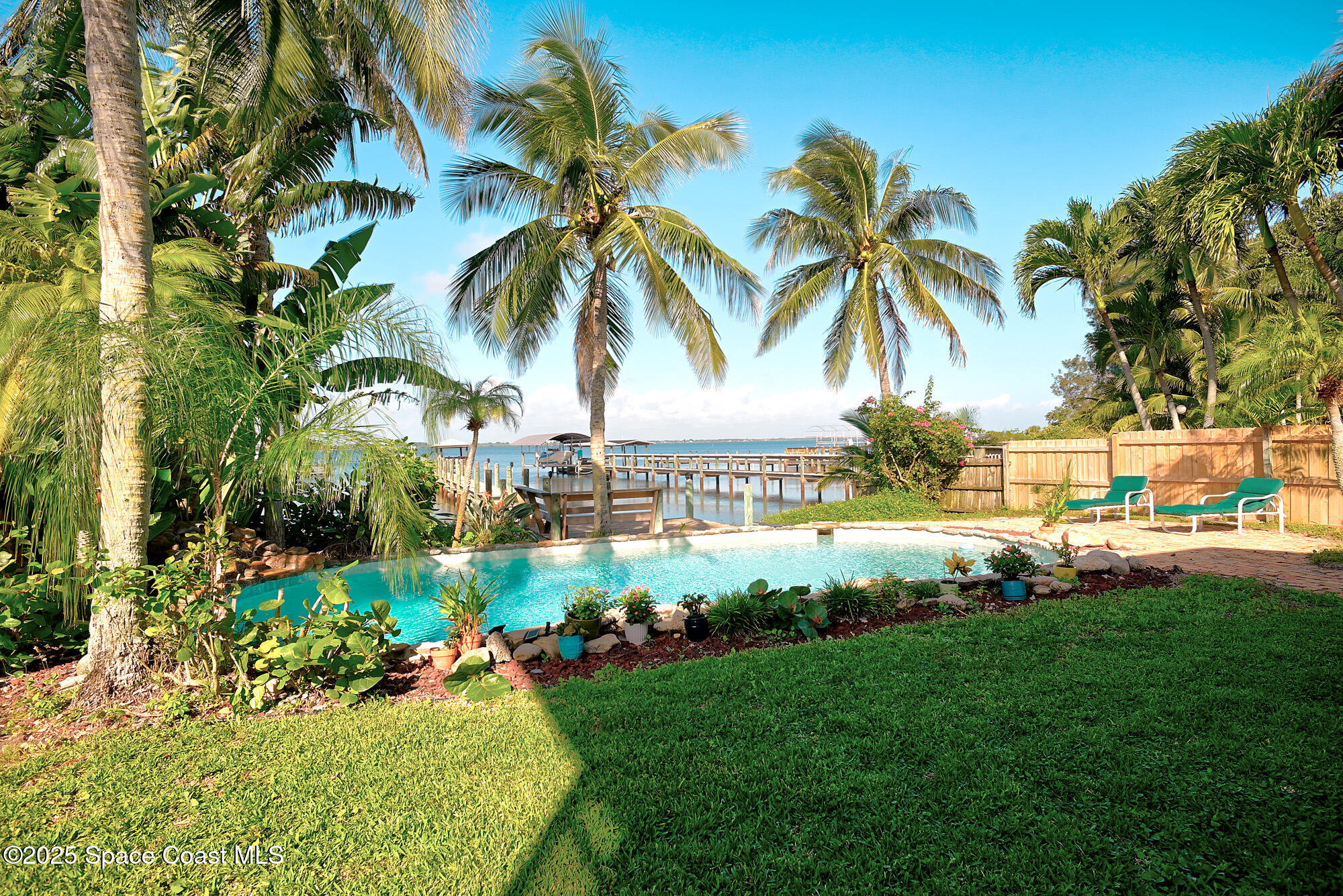 5930 Riverside Drive Melbourne Beach, FL 32951 - Photo 30 of 46 a view of a garden with palm trees