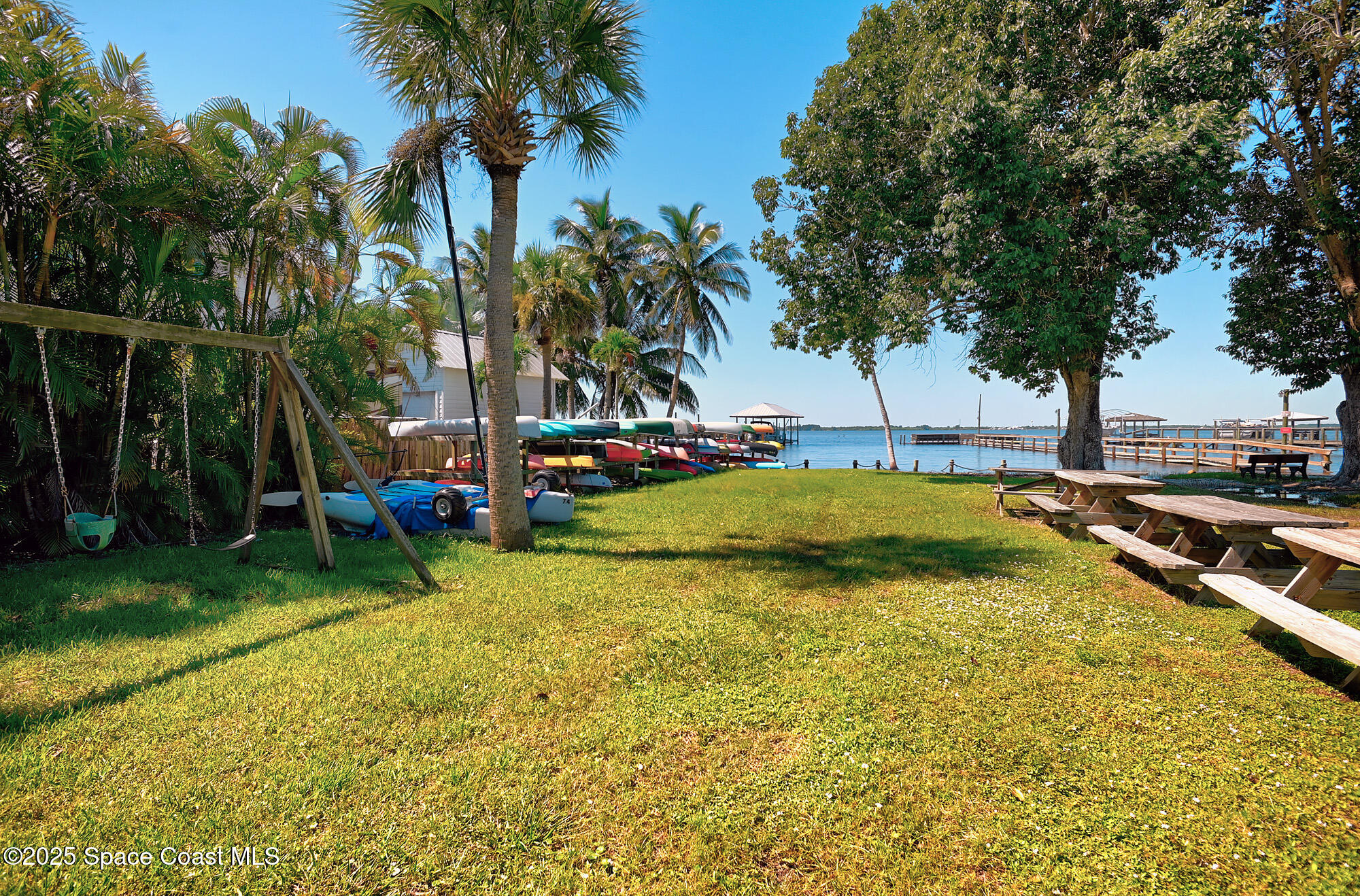 5930 Riverside Drive Melbourne Beach, FL 32951 - Photo 32 of 46 front view of a house with swimming pool and sitting area