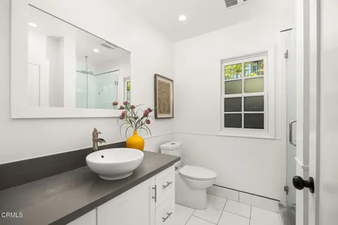 a bathroom with a sink toilet and mirror