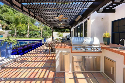 a view of a porch with furniture and garden