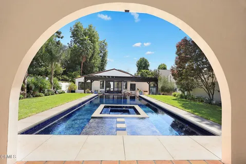 a view of a swimming pool with a yard