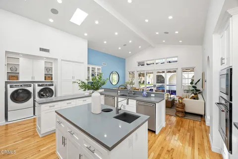 a kitchen with a stove a refrigerator and a stove top oven