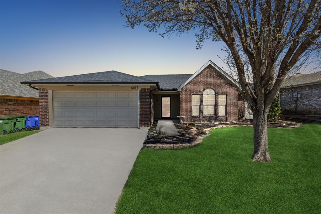 6013 Sundown Drive Watauga, TX 76148 - Photo 1 of 1 a front view of a house with a garden