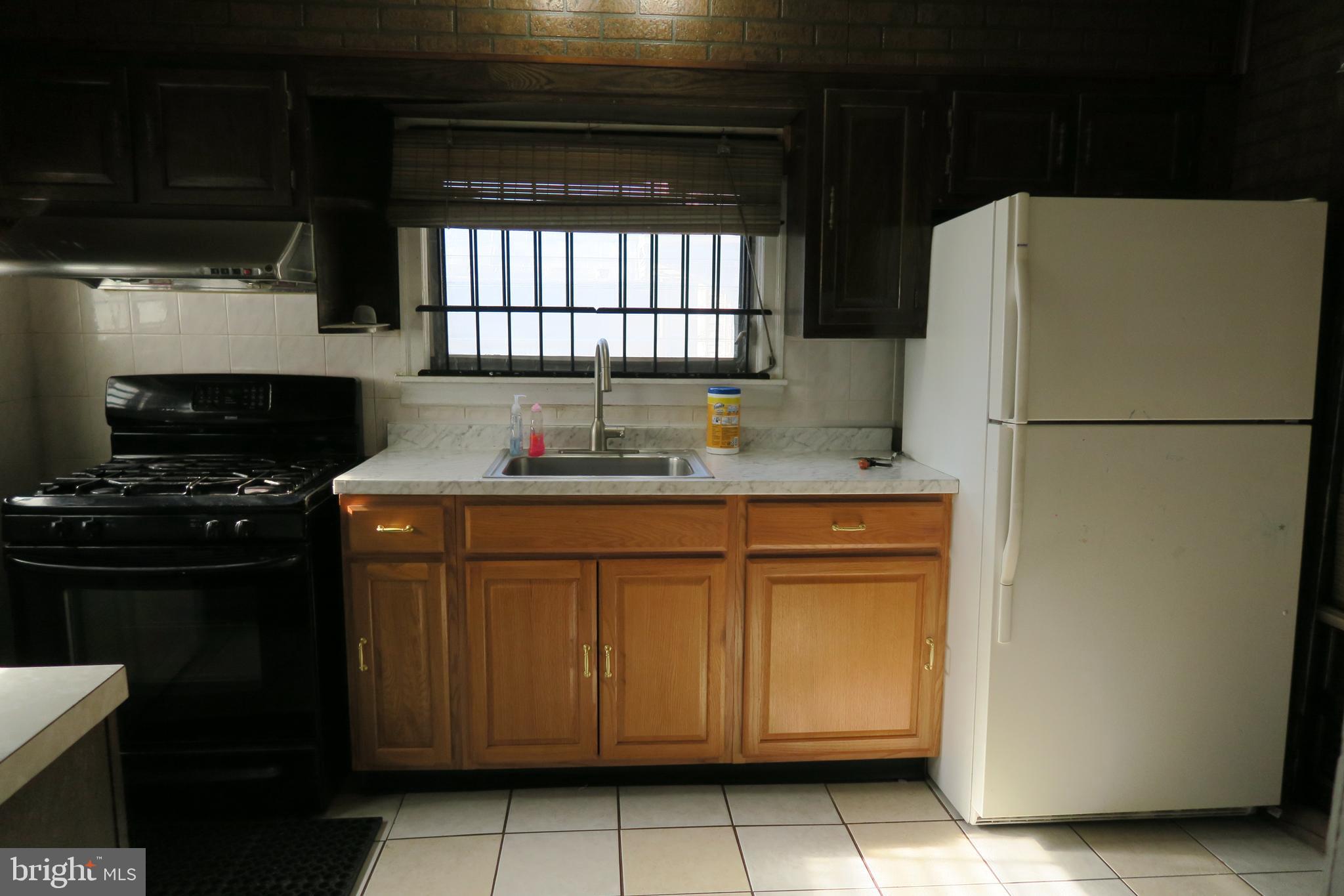 10 Overhill Road Upper Darby, PA 19082 - Photo 9 of 26 Kitchen with tile flooring and door to side yard
