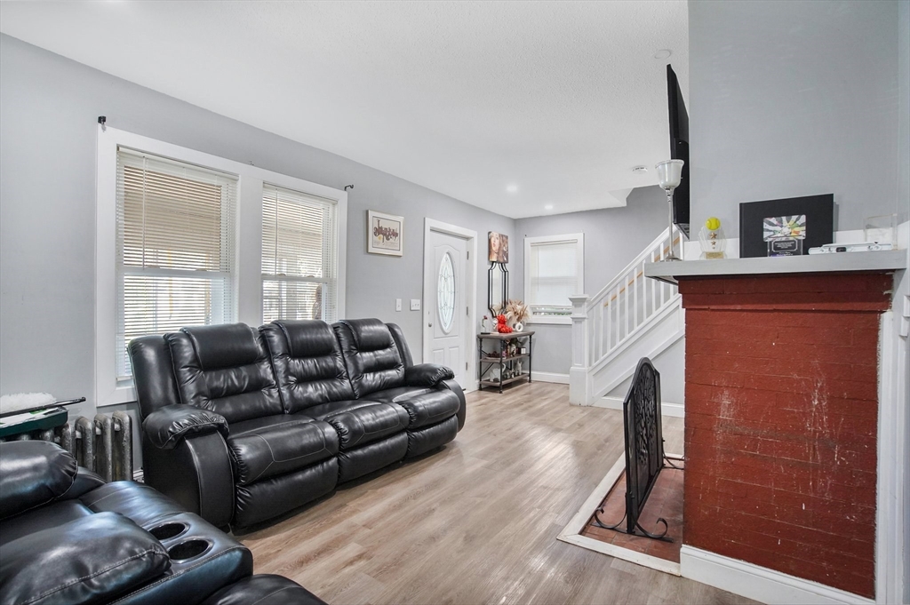 15 Eldert Street Springfield, MA 01109 - Photo 12 of 28 a living room with furniture and a fireplace