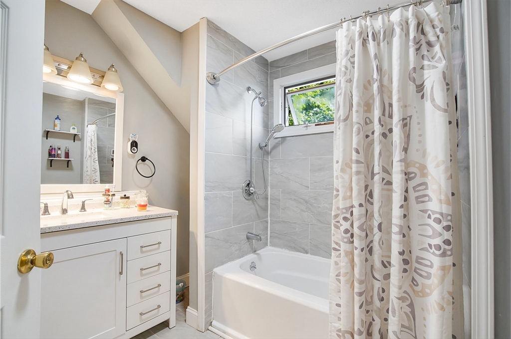 15 Eldert Street Springfield, MA 01109 - Photo 14 of 28 a bathroom with a sink double vanity mirror and a bathtub