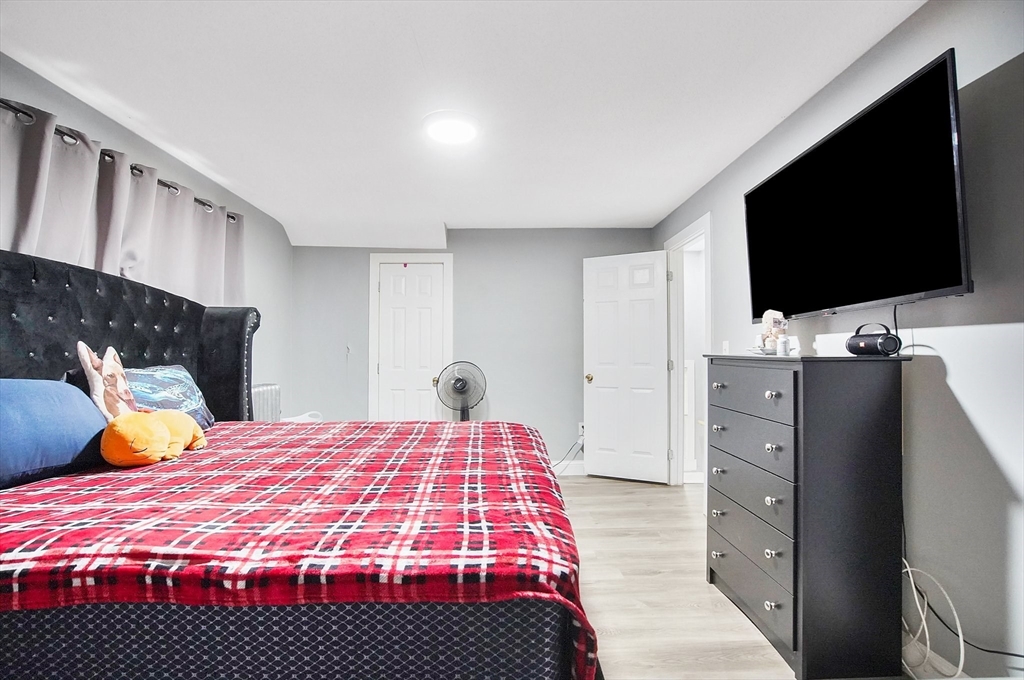 15 Eldert Street Springfield, MA 01109 - Photo 16 of 28 a bedroom with a bed and flat screen tv
