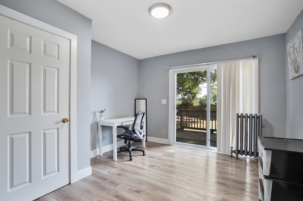 15 Eldert Street Springfield, MA 01109 - Photo 17 of 28 an empty room with wooden floor and windows