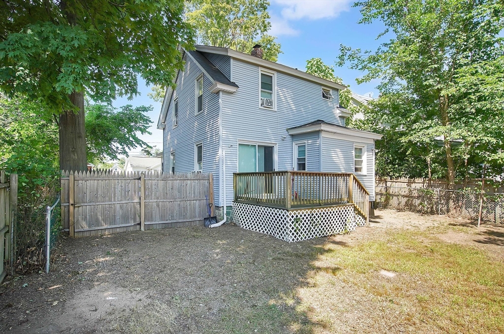 15 Eldert Street Springfield, MA 01109 - Photo 21 of 28 a view of a small house in front of a yard with wooden fence and a large tree