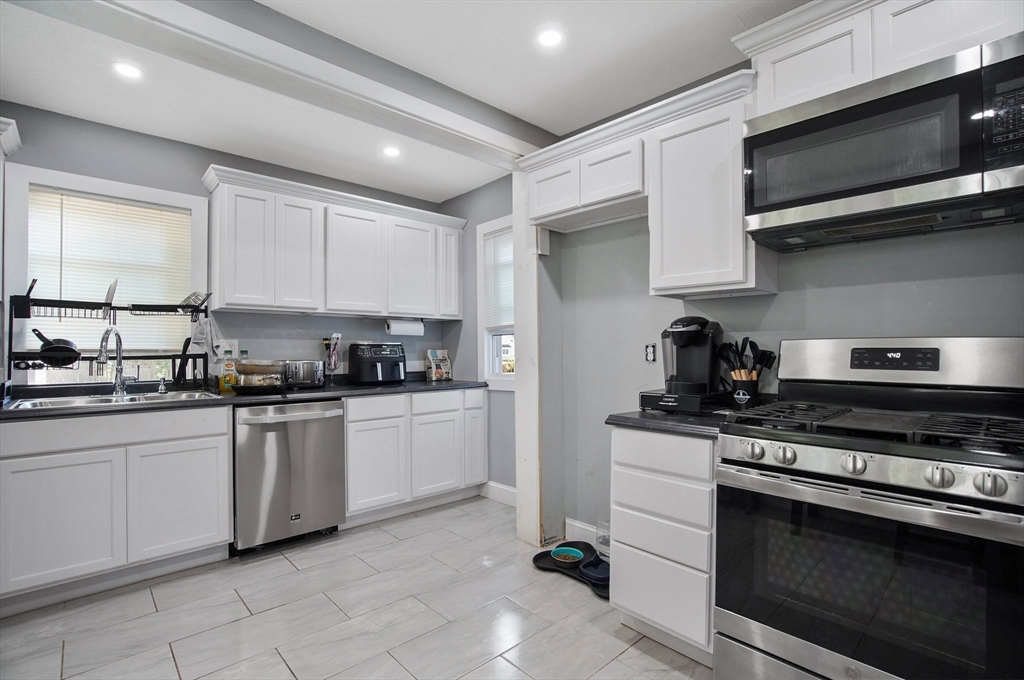 15 Eldert Street Springfield, MA 01109 - Photo 3 of 28 a kitchen with stainless steel appliances granite countertop a sink and a stove