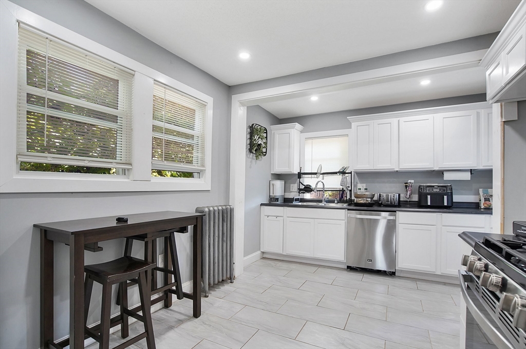 15 Eldert Street Springfield, MA 01109 - Photo 4 of 28 a kitchen with stainless steel appliances granite countertop a stove and a refrigerator