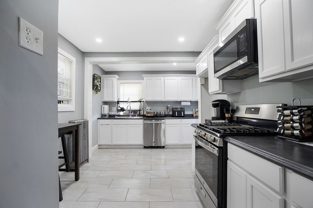 15 Eldert Street Springfield, MA 01109 - Photo 5 of 28 a kitchen with a sink cabinets and stainless steel appliances