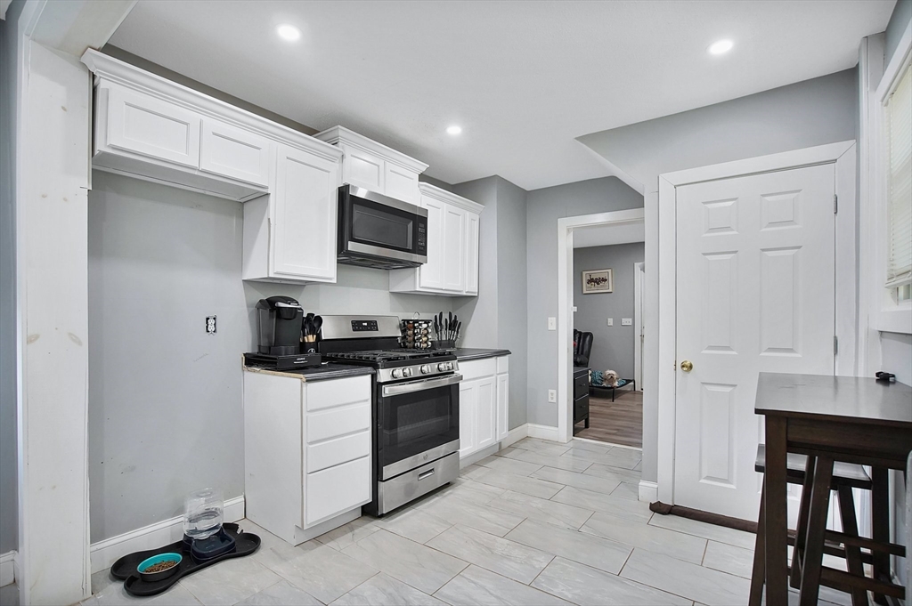 15 Eldert Street Springfield, MA 01109 - Photo 8 of 28 a kitchen with stainless steel appliances granite countertop a stove a sink and a refrigerator
