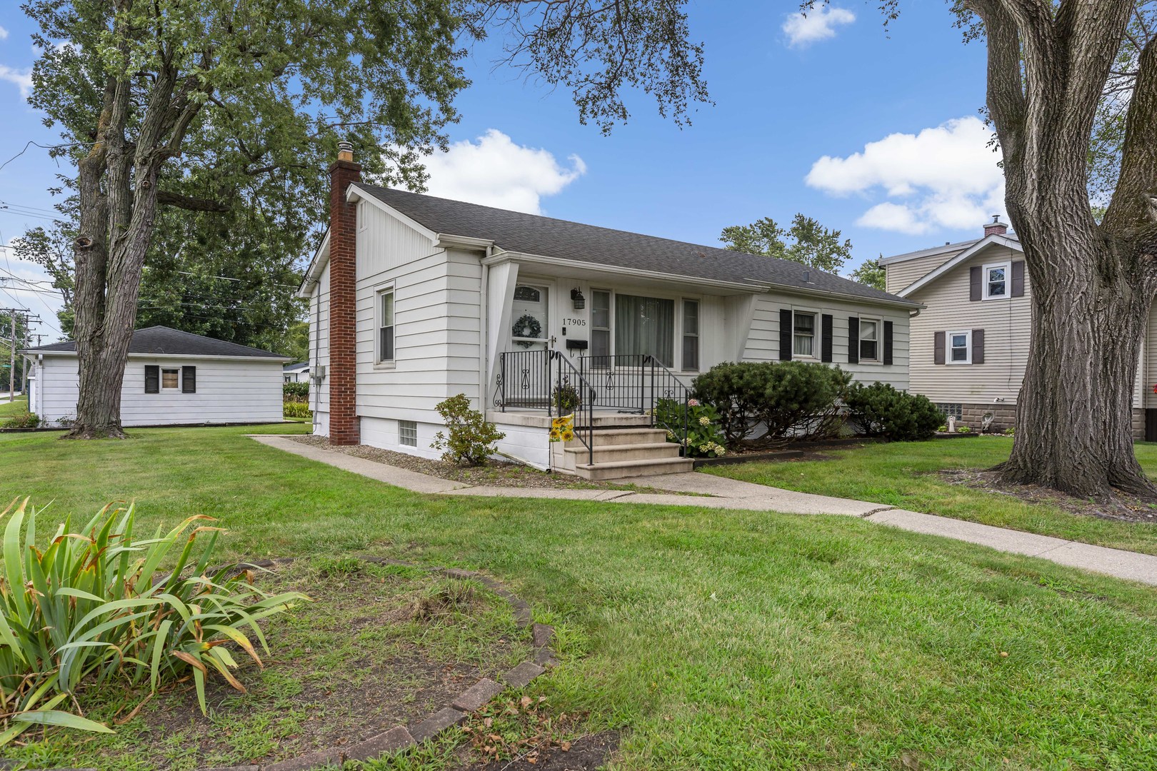 17905 Ridgewood Avenue Lansing, IL 60438 - Photo 1 of 18 a front view of house with yard and green space