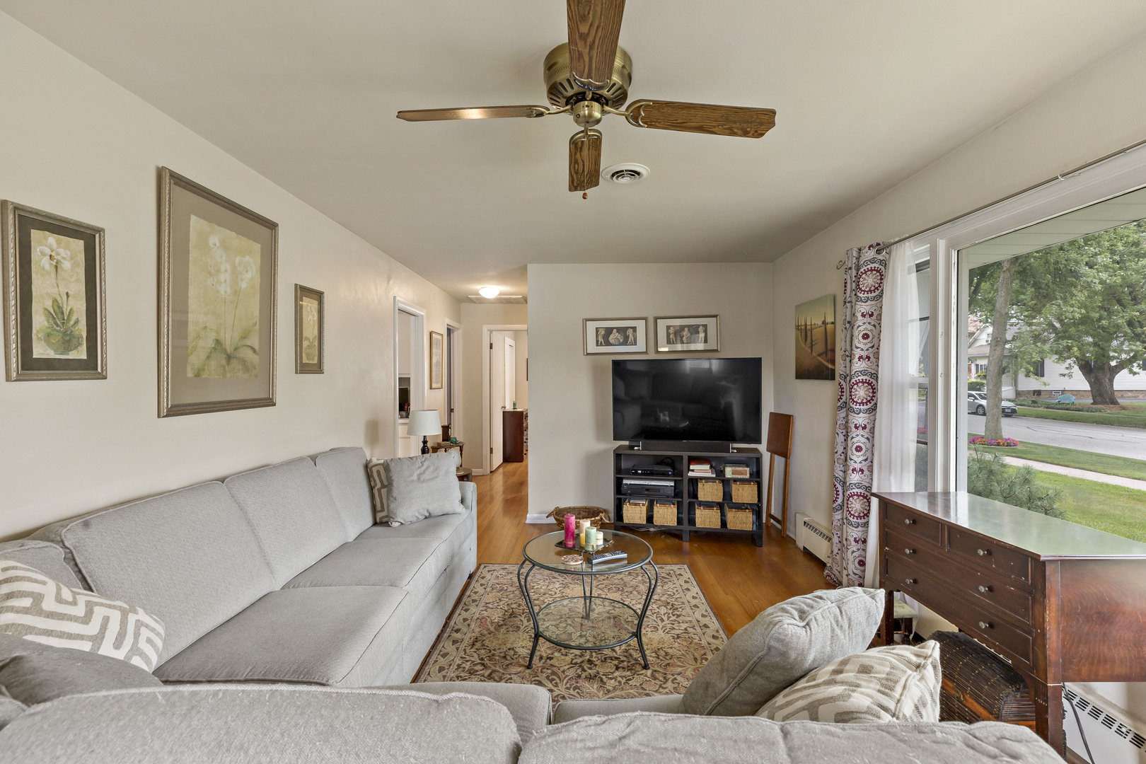 17905 Ridgewood Avenue Lansing, IL 60438 - Photo 4 of 18 a living room with furniture and a flat screen tv with wooden floor