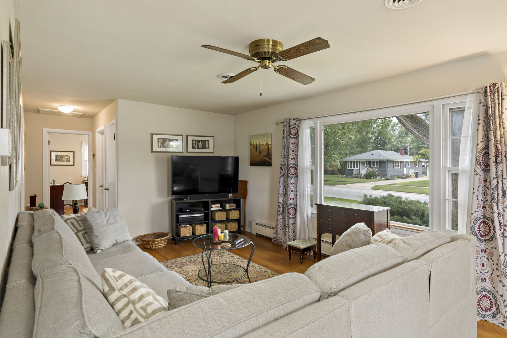 17905 Ridgewood Avenue Lansing, IL 60438 - Photo 5 of 18 a living room with furniture a large window and a flat screen tv