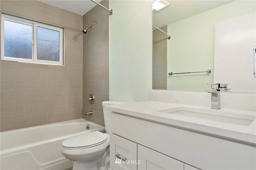 742 North 92nd Street Seattle, WA 98103 - Photo 13 of 16 a bathroom with a sink toilet vanity and shower